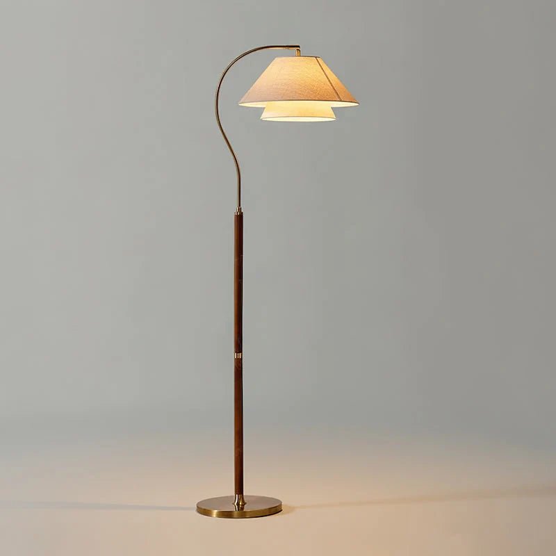 Modern Scandinavian floor lamp featuring layered fabric shades and an elegant arched frame, perfect for stylish home decor and ambient lighting. 0