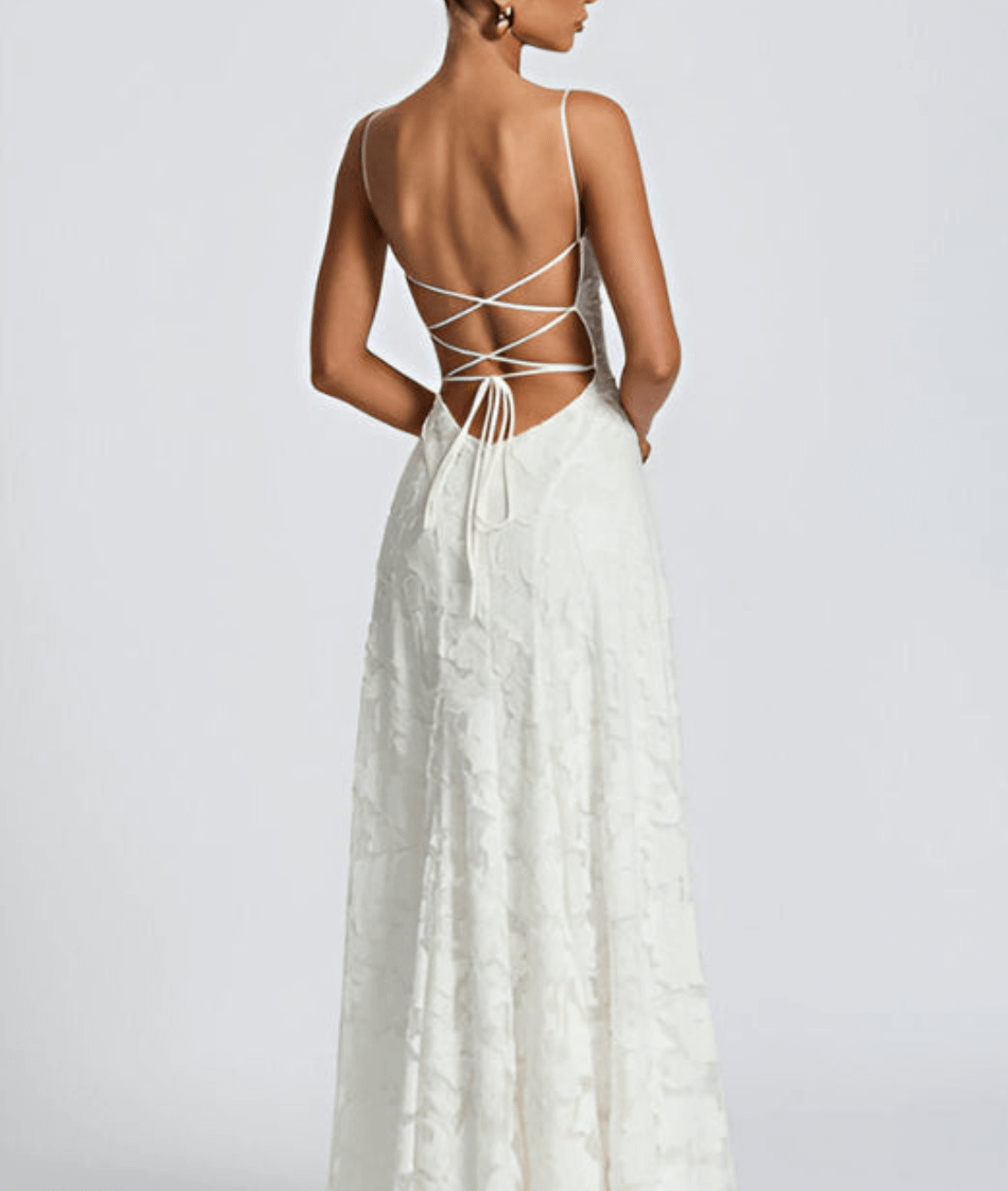 Floral maxi dress featuring a lace-up back and spaghetti straps, crafted from textured fabric, perfect for elegant occasions. 1