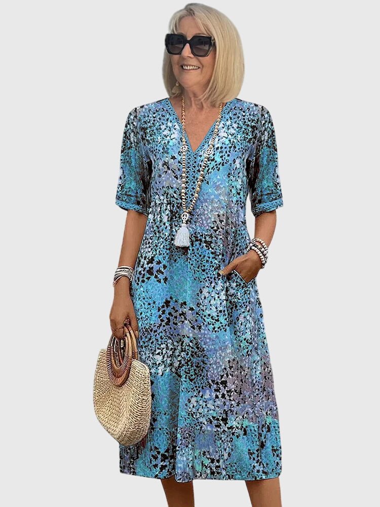 Floral midi dress featuring a chic design and lightweight fabric, perfect for elegant women's fashion. 2