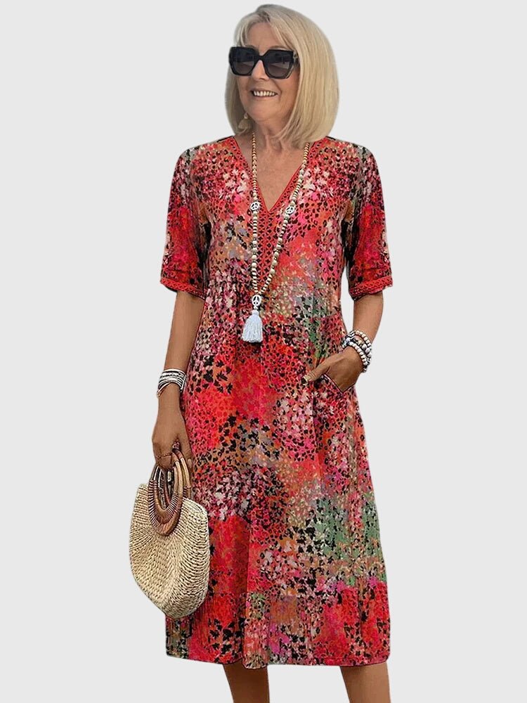 Floral midi dress featuring a chic design and lightweight fabric, perfect for elegant women's fashion. 1