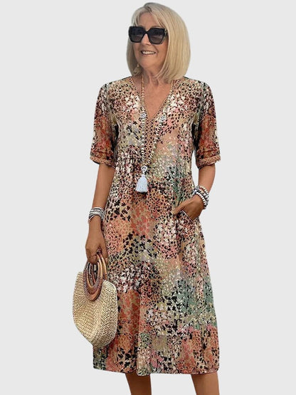 Floral midi dress featuring a chic design and lightweight fabric, perfect for elegant women's fashion. 0