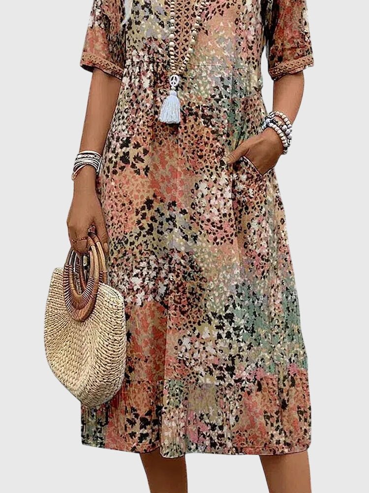 Floral midi dress featuring a chic design and lightweight fabric, perfect for elegant women's fashion. 6