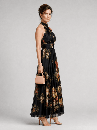 Floral midi dress featuring a defined waist and halter neck, designed for summer weddings, made from lightweight, flowing fabric. 3