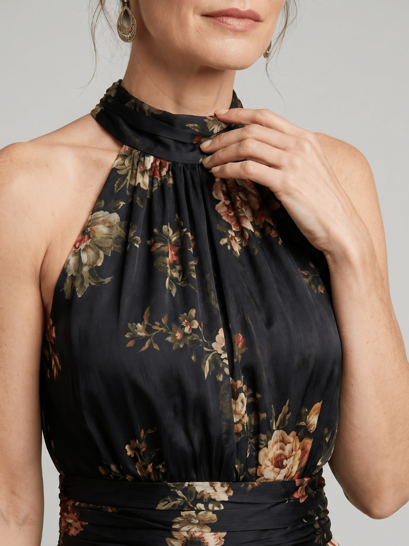 Floral midi dress featuring a defined waist and halter neck, designed for summer weddings, made from lightweight, flowing fabric. 2