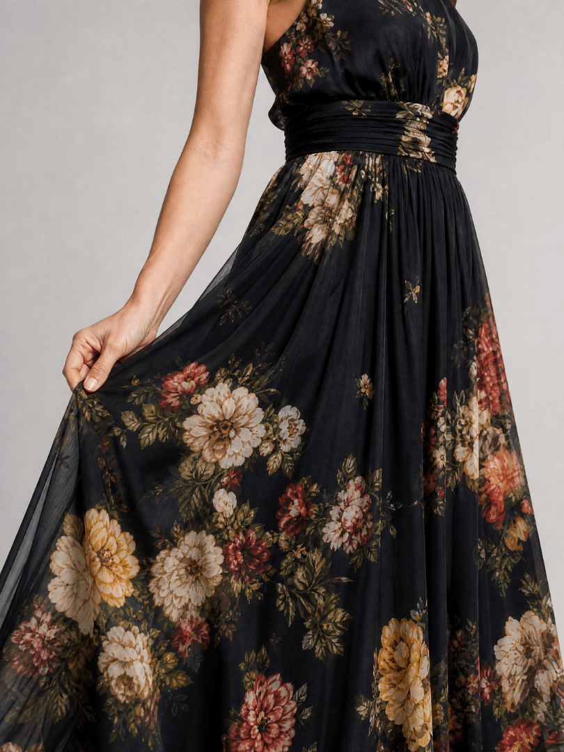 Floral midi dress featuring a defined waist and halter neck, designed for summer weddings, made from lightweight, flowing fabric. 1