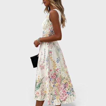 Floral midi dress featuring a vibrant watercolor print and cinched waist, perfect for summer weddings and special occasions. 1
