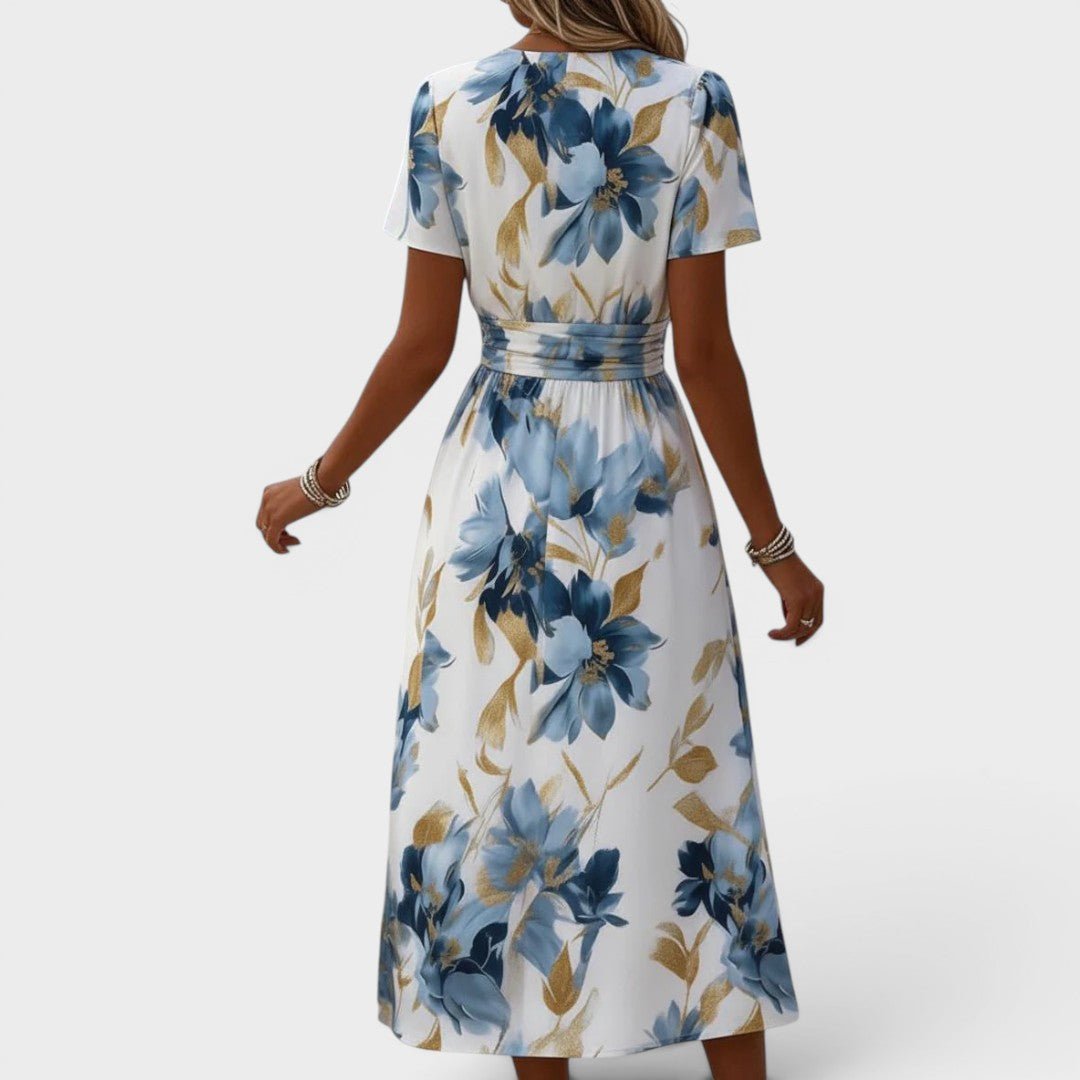 Floral wrap midi dress featuring a ruched waist and gold accents, perfect for summer weddings and elegant occasions. 3