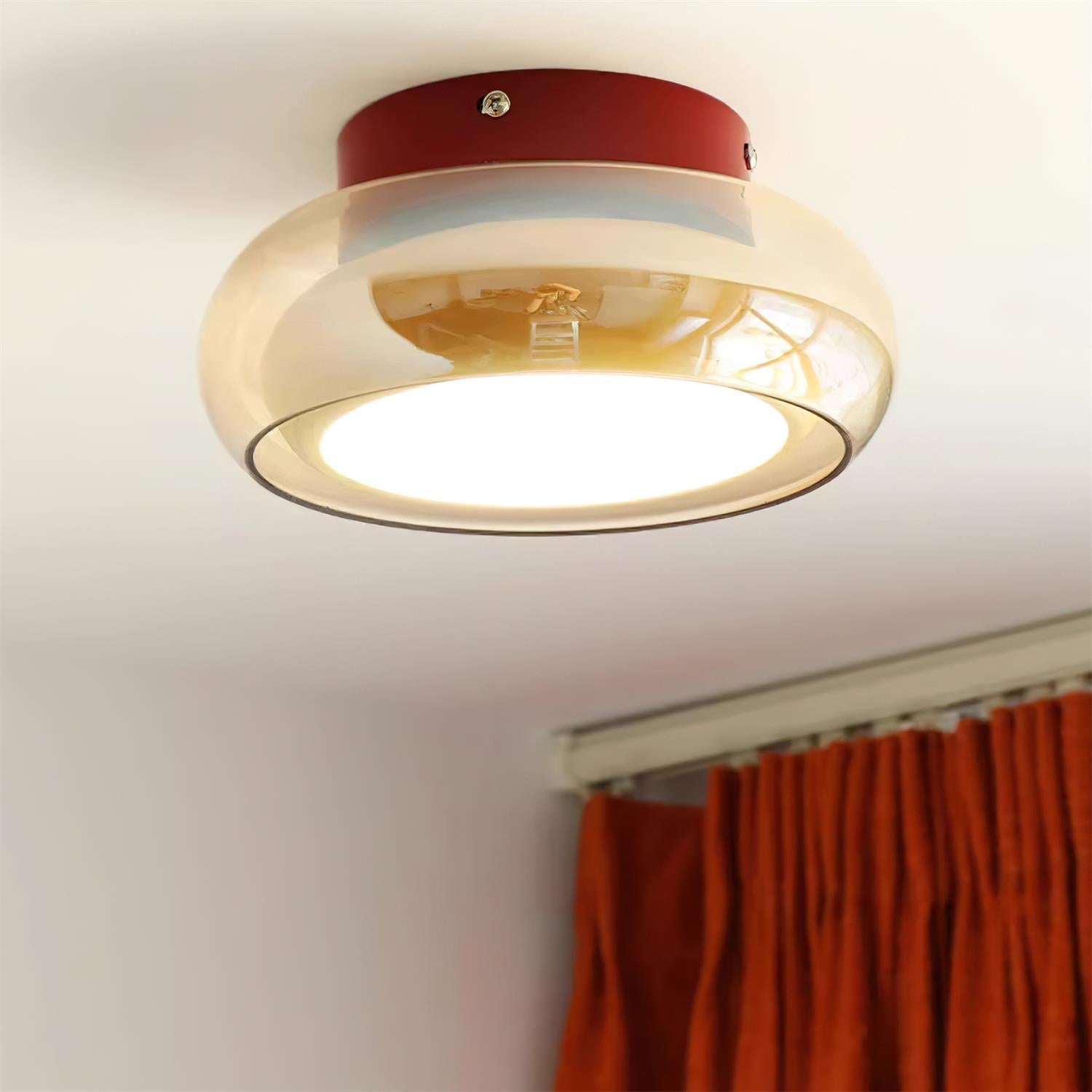 Flush mount ceiling light featuring a sleek modern metal design, integrated LED technology, and a round glass shade, perfect for enhancing the ambiance of bedrooms and living 1
