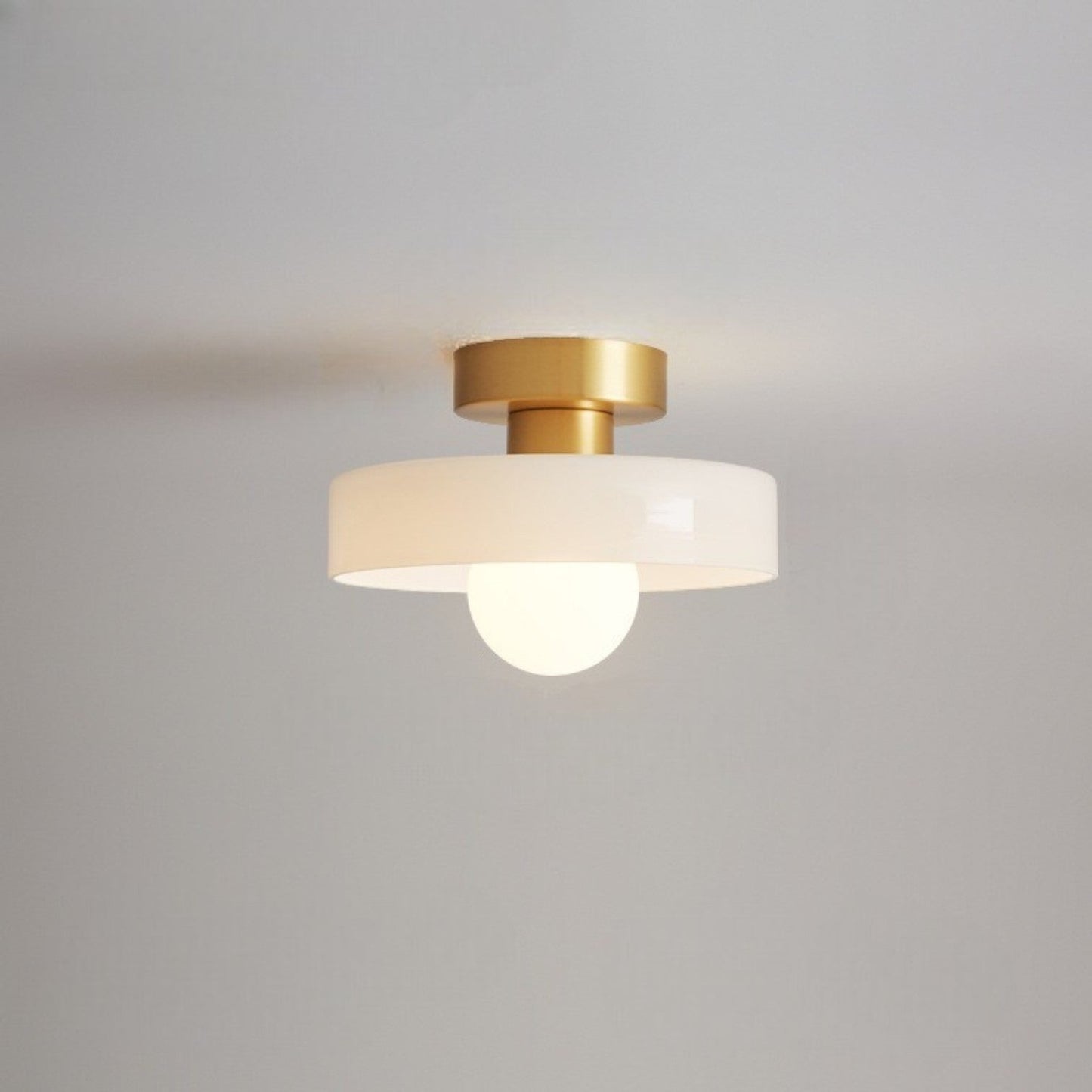 Modern brass and glass flush mount ceiling light designed for dining rooms or halls, featuring LED compatibility for energy-efficient illumination. 13