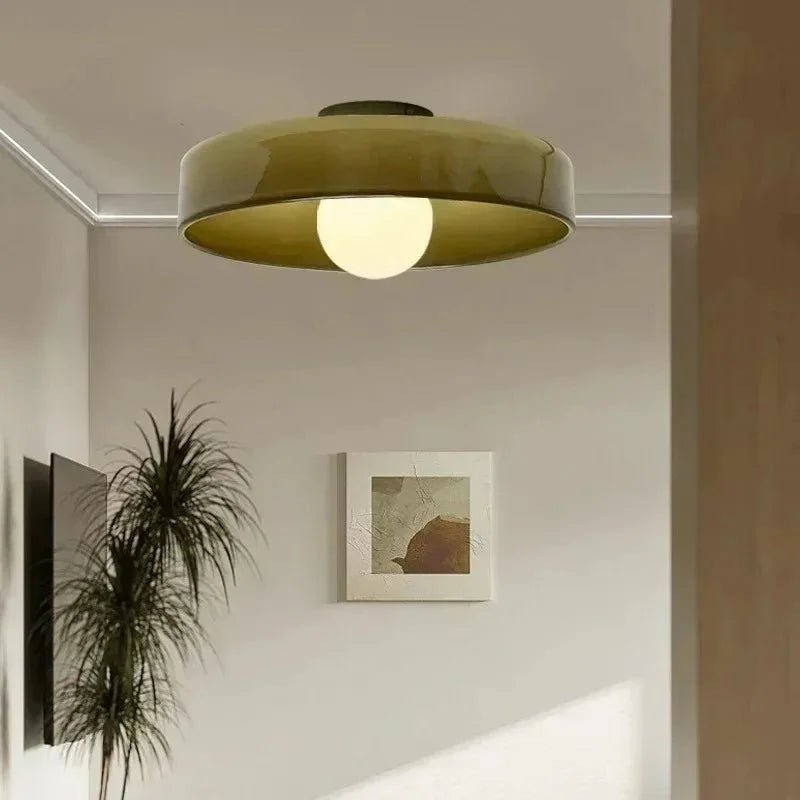 Flush mount ceiling light featuring a sleek Scandinavian glass design, emitting soft, warm lighting, perfect for enhancing modern interior spaces. 0
