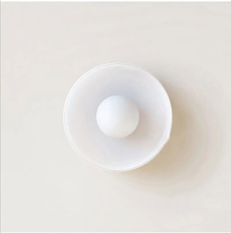 Flush mount ceiling light featuring a sleek Scandinavian glass design, emitting soft, warm lighting, perfect for enhancing modern interior spaces. 6