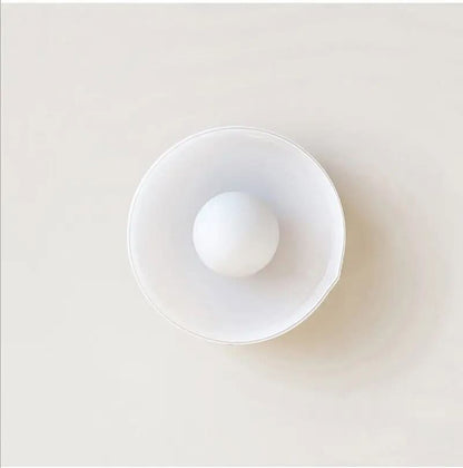 Flush mount ceiling light featuring a sleek Scandinavian glass design, emitting soft, warm lighting, perfect for enhancing modern interior spaces. 6
