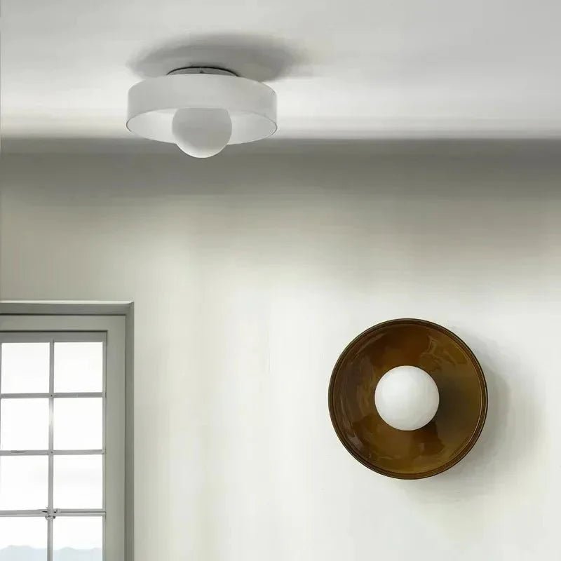 Flush mount ceiling light featuring a sleek Scandinavian glass design, emitting soft, warm lighting, perfect for enhancing modern interior spaces. 1