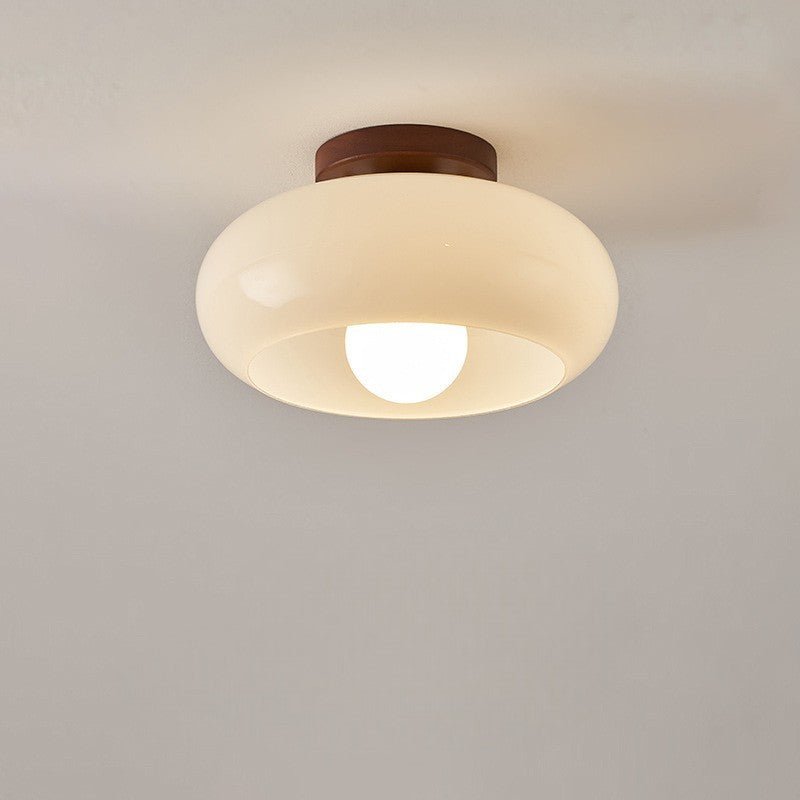 Flush mount ceiling light featuring a warm glow, elegant wooden accent, and a Bauhaus style opal glass shade, perfect for enhancing the ambiance of bedrooms 0