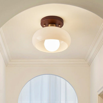 Flush mount ceiling light featuring a warm glow, elegant wooden accent, and a Bauhaus style opal glass shade, perfect for enhancing the ambiance of bedrooms 2