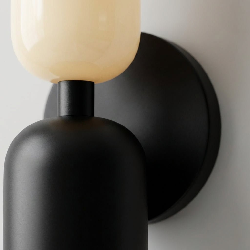 Geometric wall lamp featuring a sleek metal frame and frosted glass shade, providing soft ambient light for modern home decor. 3