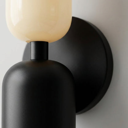 Geometric wall lamp featuring a sleek metal frame and frosted glass shade, providing soft ambient light for modern home decor. 3