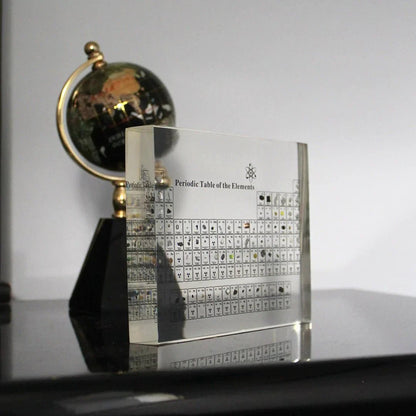 Glass periodic table display featuring real element samples, ideal for educational chemistry decor in classrooms and study spaces. 0