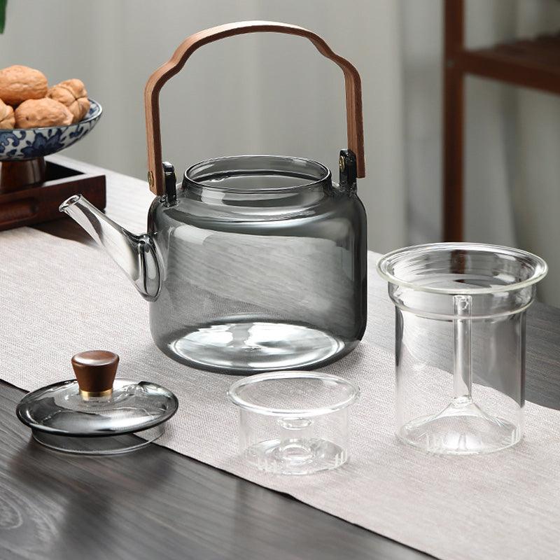 Elegant smoked glass teapot with infuser and wooden lid, perfect for brewing 1.2L of tea, combining style and functionality. 2