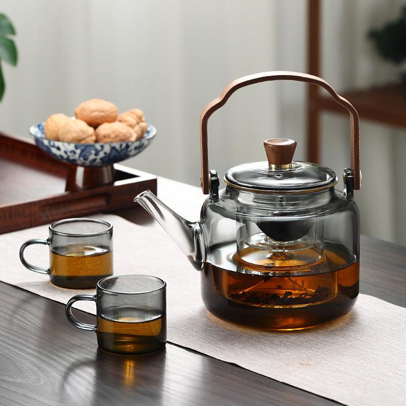 Elegant smoked glass teapot with infuser and wooden lid, perfect for brewing 1.2L of tea, combining style and functionality. 3
