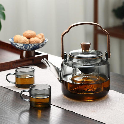 Elegant smoked glass teapot with infuser and wooden lid, perfect for brewing 1.2L of tea, combining style and functionality. 3