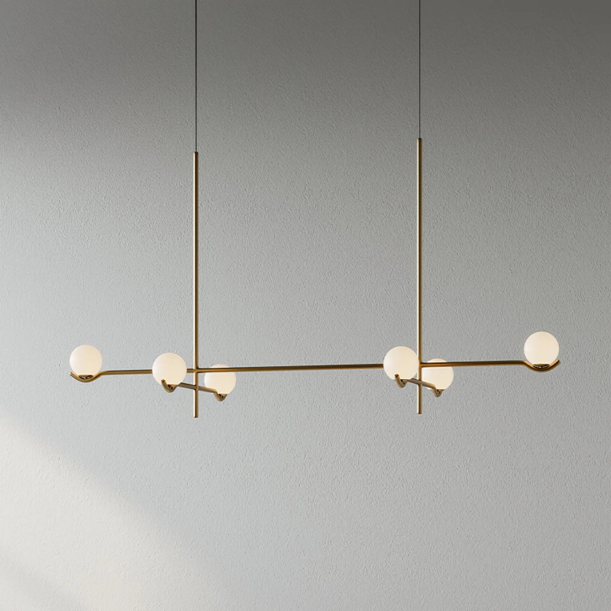 Globe pendant light featuring a modern white glass shade and sleek metal design, adjustable height for kitchen island or dining room illumination. 10