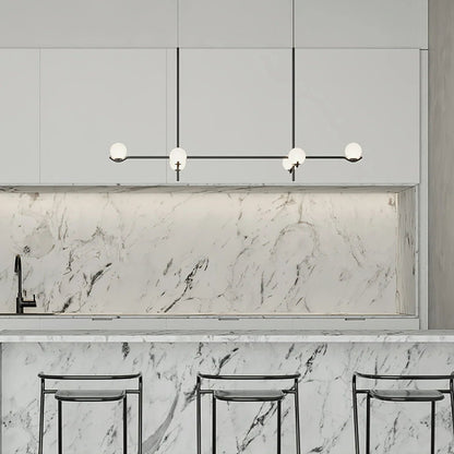 Globe pendant light featuring a modern white glass shade and sleek metal design, adjustable height for kitchen island or dining room illumination. 8