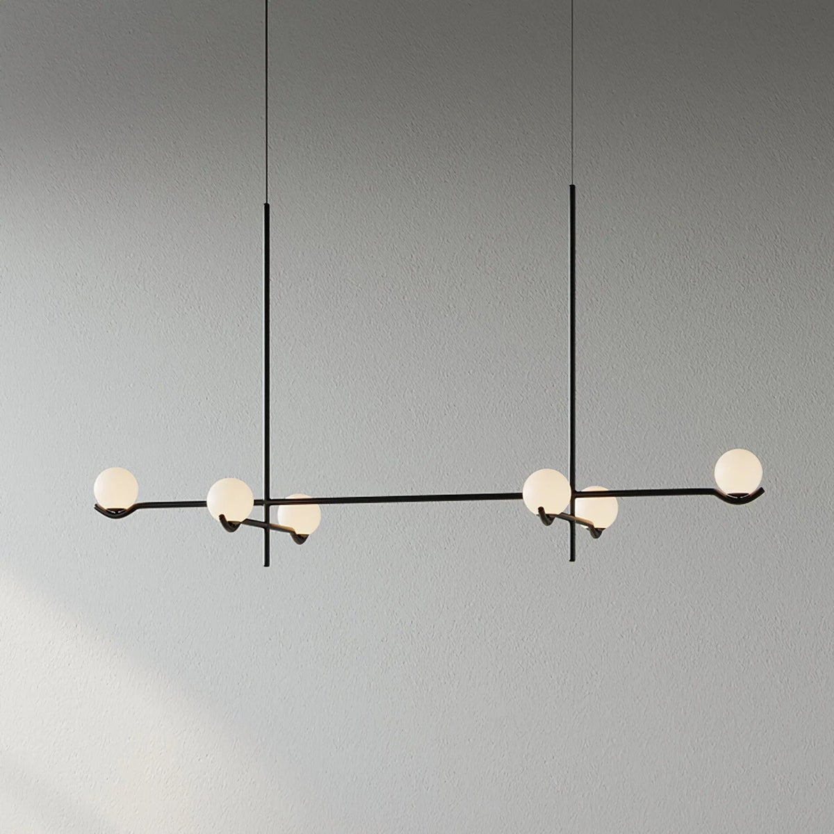 Globe pendant light featuring a modern white glass shade and sleek metal design, adjustable height for kitchen island or dining room illumination. 13