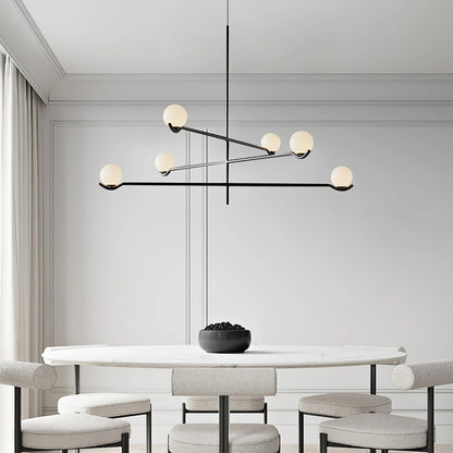 Globe pendant light featuring a modern white glass shade and sleek metal design, adjustable height for kitchen island or dining room illumination. 5