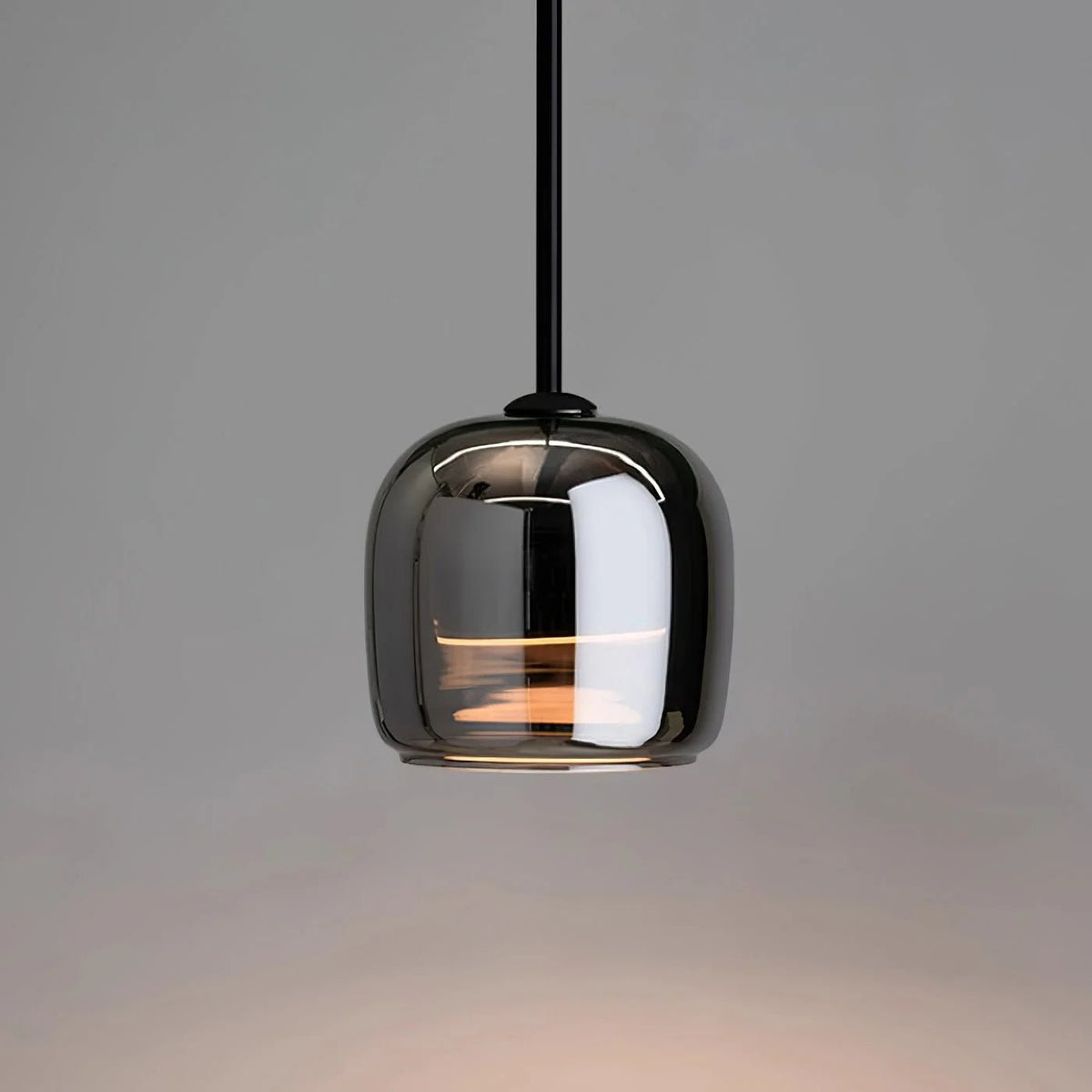 Modern globe pendant light featuring a smoky glass shade and sleek black metal finish, perfect for stylish kitchen lighting with integrated LED technology. 0