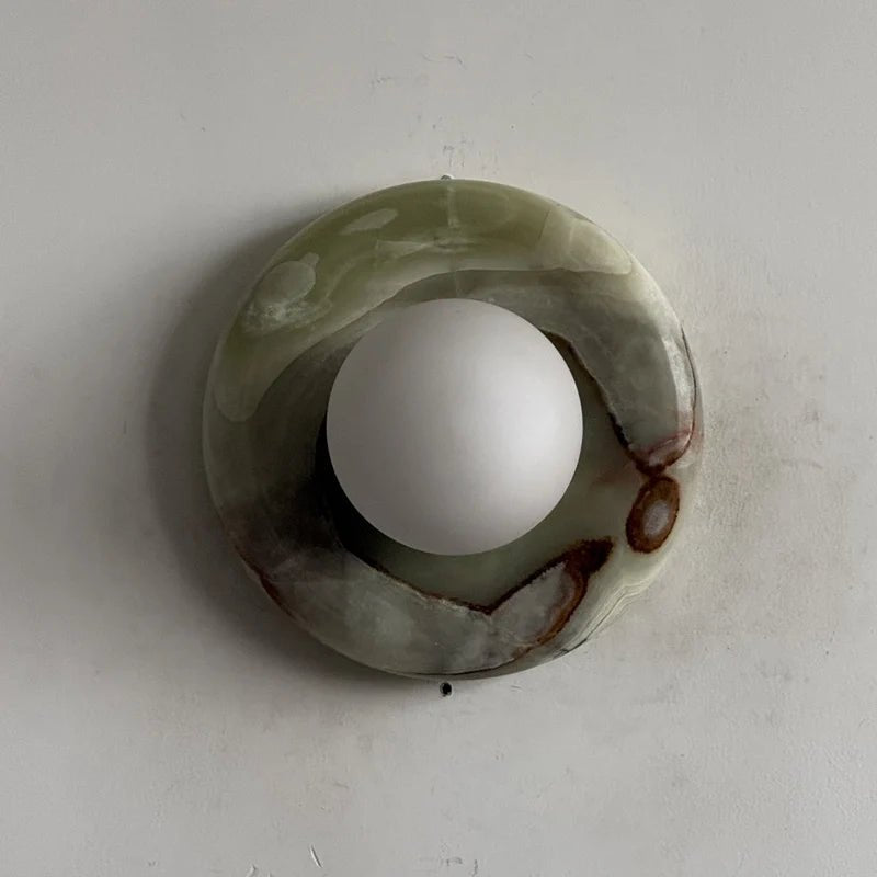 Globe Wall Light featuring a natural onyx backplate, designed as a compact ambient sconce for modern interior decor. 24