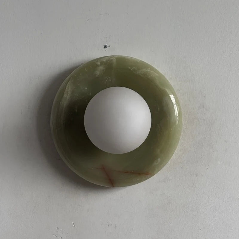 Globe Wall Light featuring a natural onyx backplate, designed as a compact ambient sconce for modern interior decor. 18