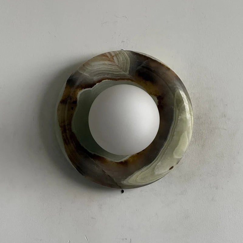 Globe Wall Light featuring a natural onyx backplate, designed as a compact ambient sconce for modern interior decor. 30