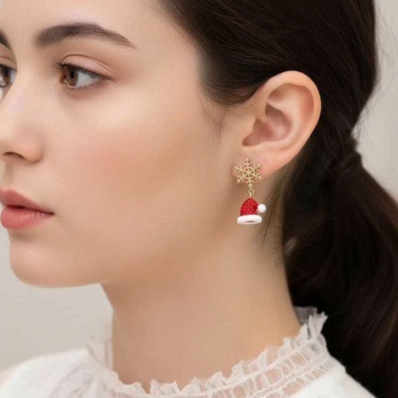 Gold dangle earrings featuring intricate snowflake and Christmas tree charms, perfect for festive holiday celebrations and seasonal fashion. 3