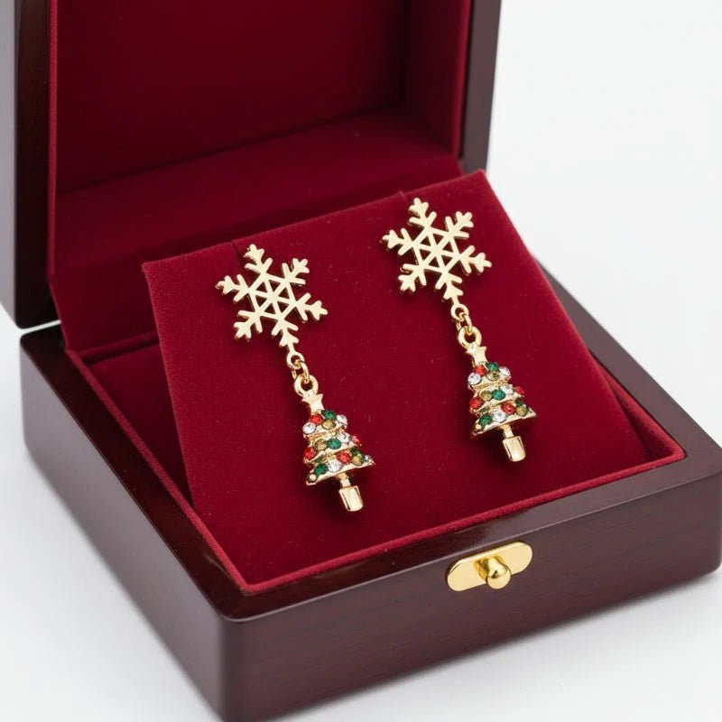 Gold dangle earrings featuring intricate snowflake and Christmas tree charms, perfect for festive holiday celebrations and seasonal fashion. 4