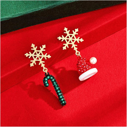 Gold dangle earrings featuring intricate snowflake and Christmas tree charms, perfect for festive holiday celebrations and seasonal fashion. 1