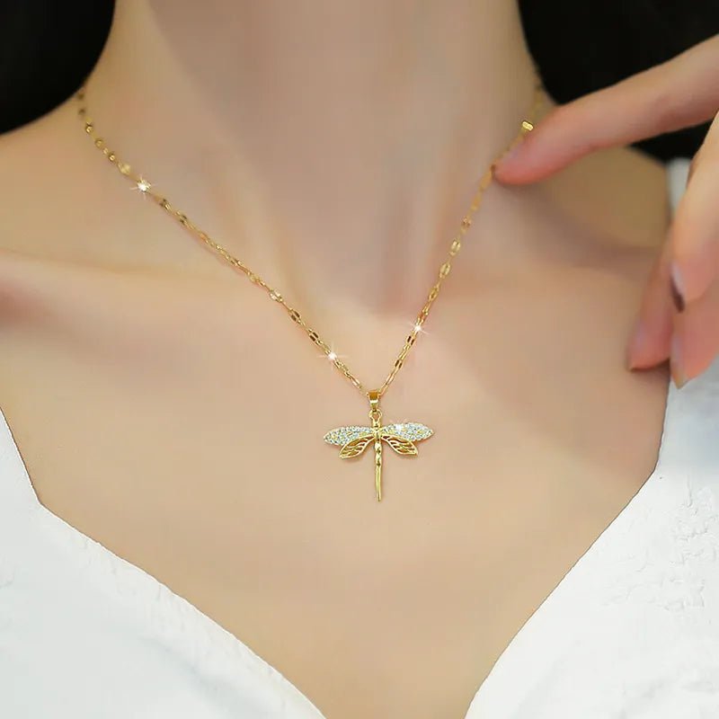 Gold dragonfly necklace featuring a sparkling crystal pendant on a 14K gold eye chain, perfect for adding an elegant touch to any outfit. 5