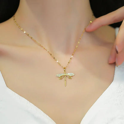 Gold dragonfly necklace featuring a sparkling crystal pendant on a 14K gold eye chain, perfect for adding an elegant touch to any outfit. 5