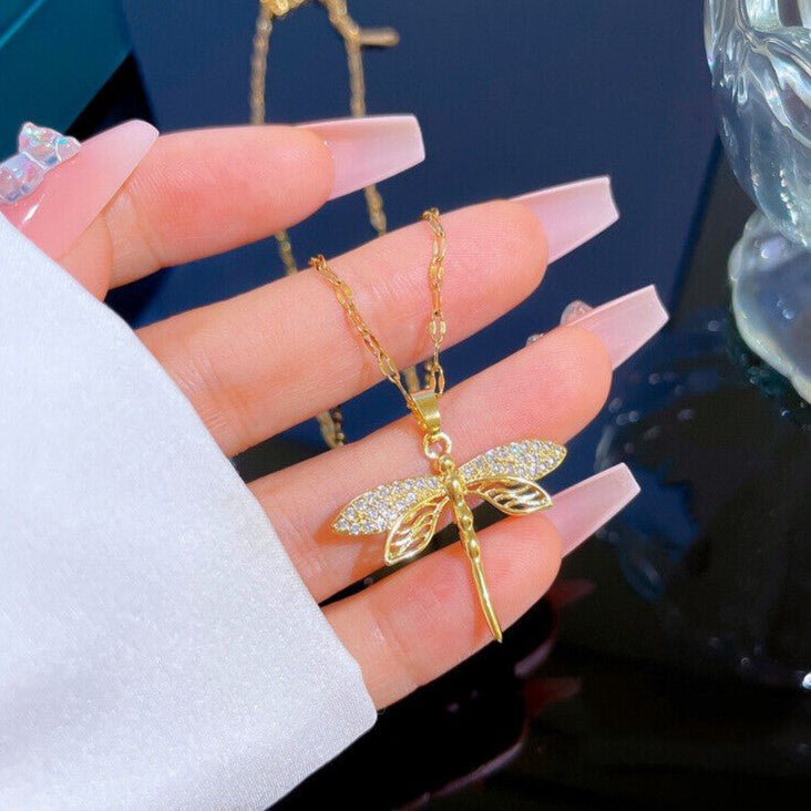 Gold dragonfly necklace featuring a sparkling crystal pendant on a 14K gold eye chain, perfect for adding an elegant touch to any outfit. 4