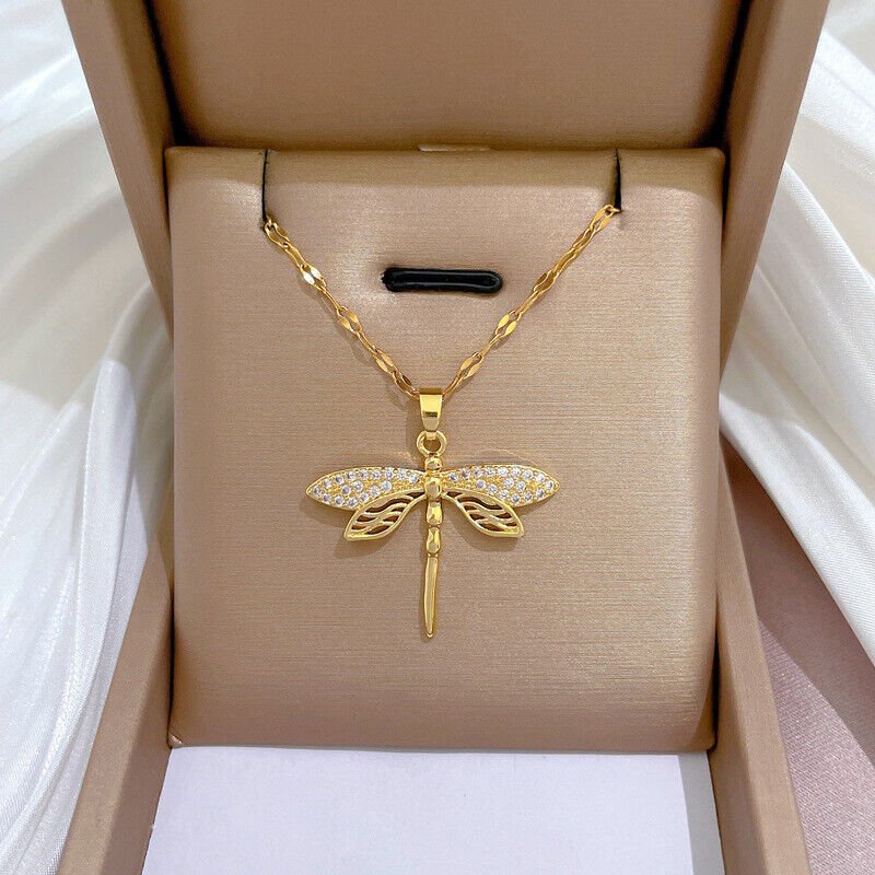 Gold dragonfly necklace featuring a sparkling crystal pendant on a 14K gold eye chain, perfect for adding an elegant touch to any outfit. 3