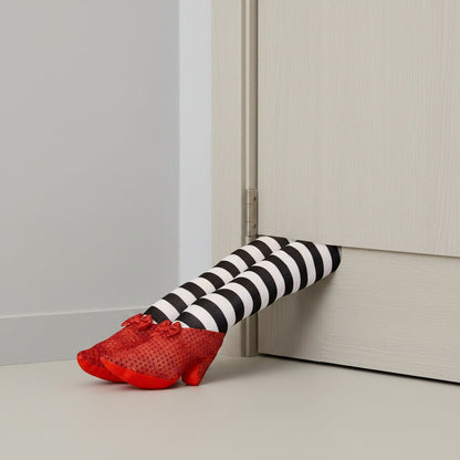 Halloween door stopper featuring whimsical witch legs with a striped design, perfect for festive indoor and outdoor decor. 1