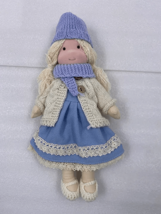 Handmade Waldorf doll featuring soft fabrics and colorful knitted clothing, measuring 28cm, designed for durability and easy cleaning, perfect for kids. 0