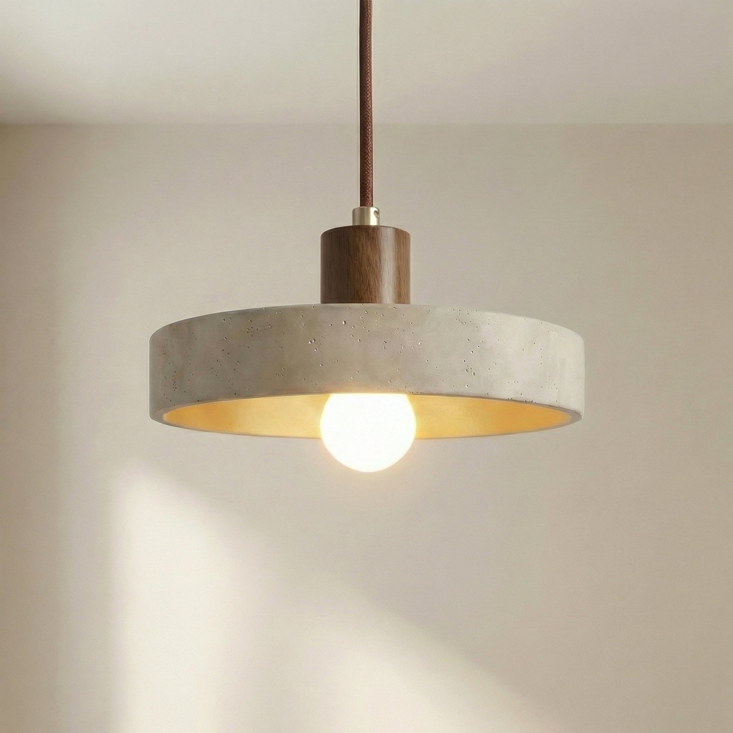 Hanging lamp with adjustable height featuring a warm LED light, designed in a Bauhaus-inspired minimalist style with a sleek travertine pendant. 4