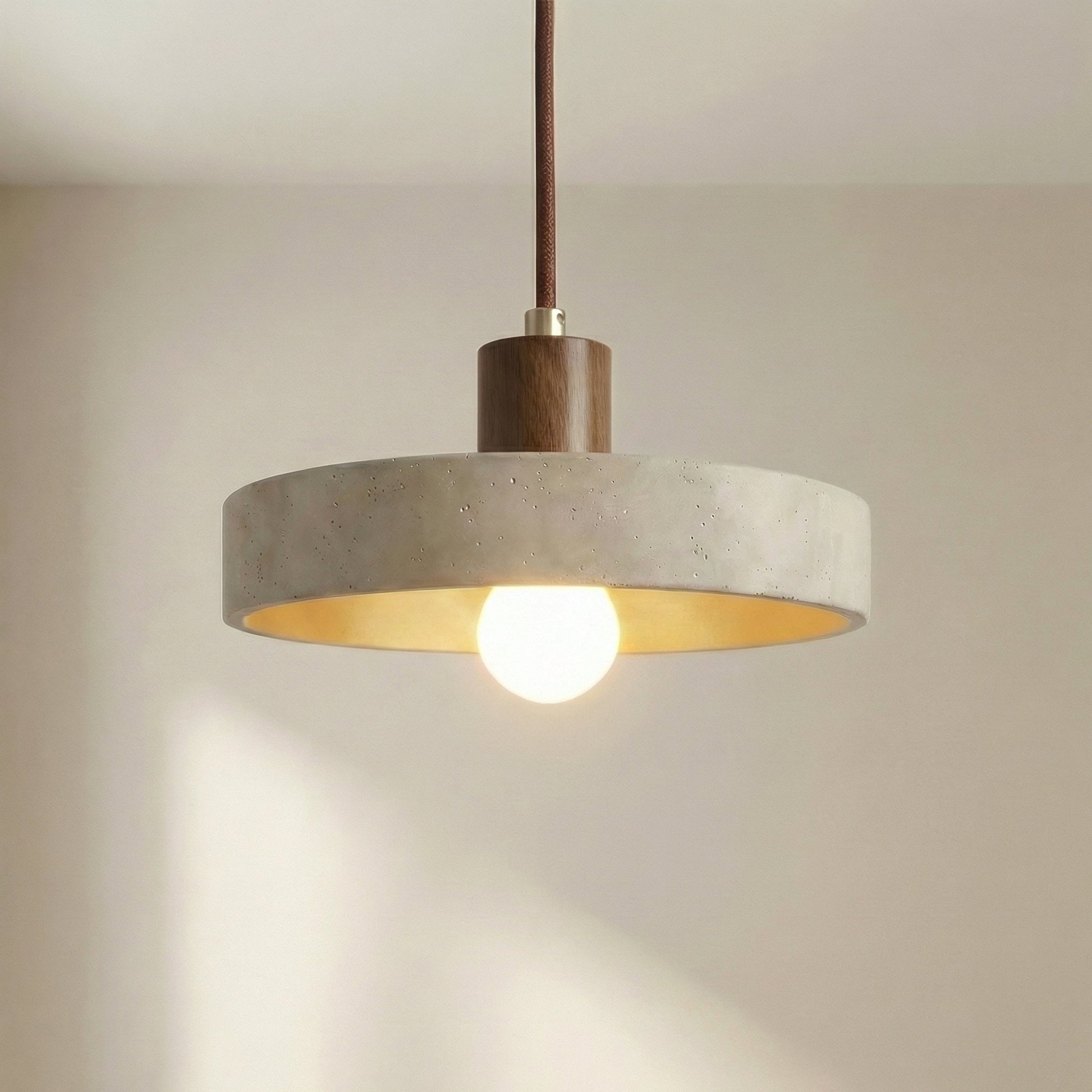 Hanging lamp with adjustable height featuring a warm LED light, designed in a Bauhaus-inspired minimalist style with a sleek travertine pendant. 4