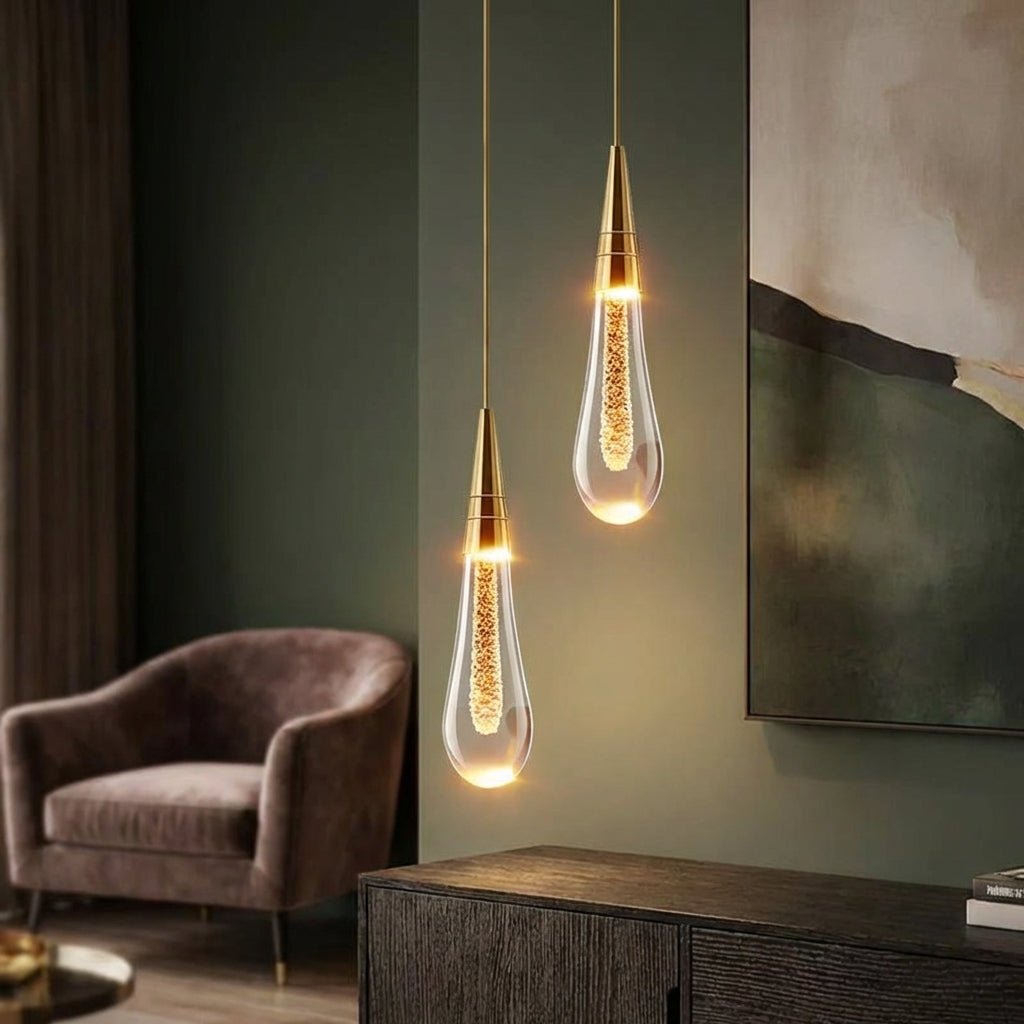 Modern kitchen pendant light featuring a stylish hanging lamp with a drop glass design, emitting warm white ambient lighting for a cozy atmosphere. 1
