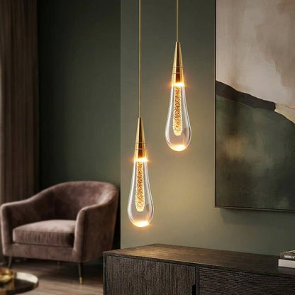 Modern kitchen pendant light featuring a stylish hanging lamp with a drop glass design, emitting warm white ambient lighting for a cozy atmosphere. 1