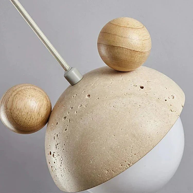 Hanging lamp featuring a warm LED light and a natural travertine finish, showcasing a playful minimalist design perfect for modern interiors. 4