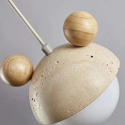 Hanging lamp featuring a warm LED light and a natural travertine finish, showcasing a playful minimalist design perfect for modern interiors. 4