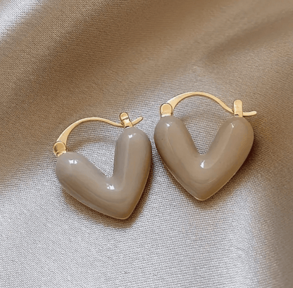 Heart-shaped earrings featuring a pearl accent, crafted from durable metal, showcasing an elegant design perfect for women's fashion. 2