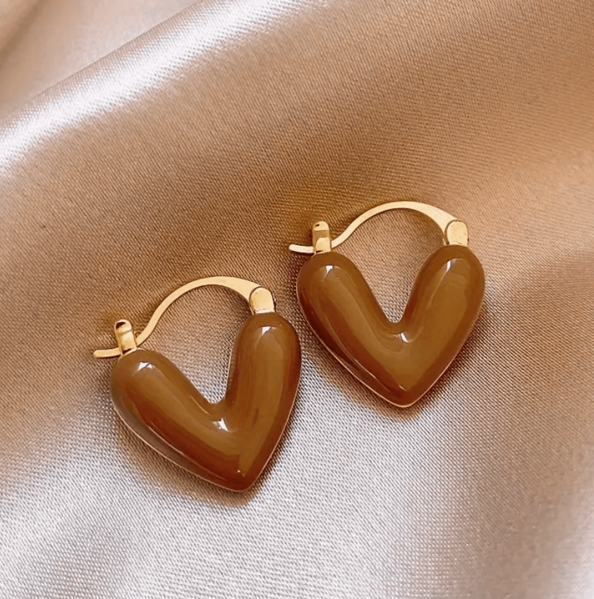 Heart-shaped earrings featuring a pearl accent, crafted from durable metal, showcasing an elegant design perfect for women's fashion. 5